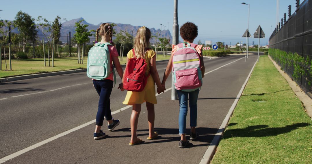 Three Schoolgirls Walking Together on Suburban Road - Free Images, Stock Photos and Pictures on Pikwizard.com