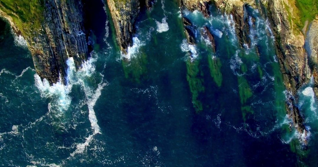 Aerial View of Rugged Cliffs and Turquoise Sea Waves