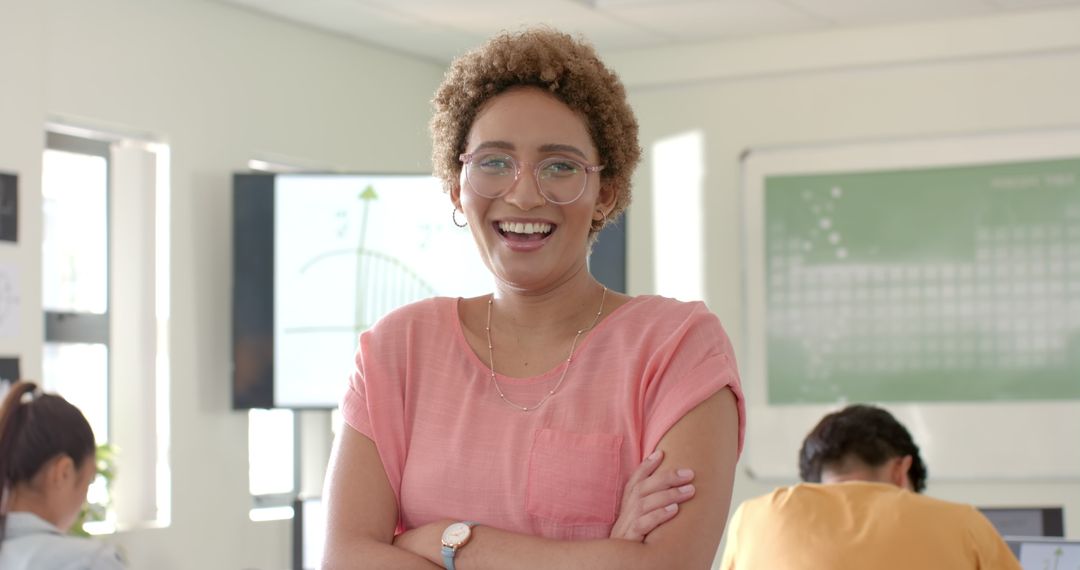 Confident Teacher Smiling in Classroom with Students in Background