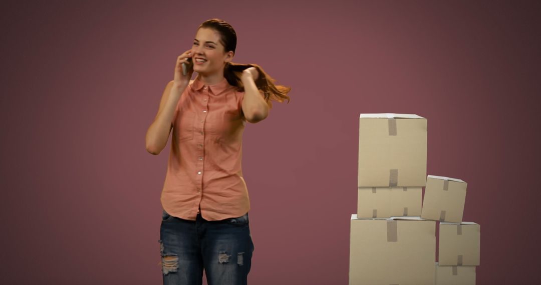 Woman Discussing Logistics on Smartphone with Shipping Boxes