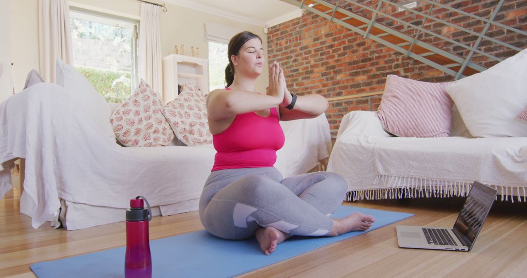 Woman Meditating in Trendy Home with Laptop - Free Images, Stock Photos and Pictures on Pikwizard.com