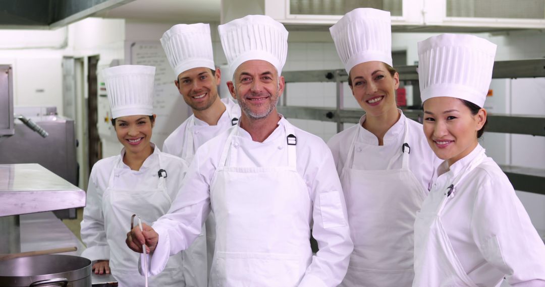 Group of Professional Chefs Posing together in Kitchen - Free Images, Stock Photos and Pictures on Pikwizard.com