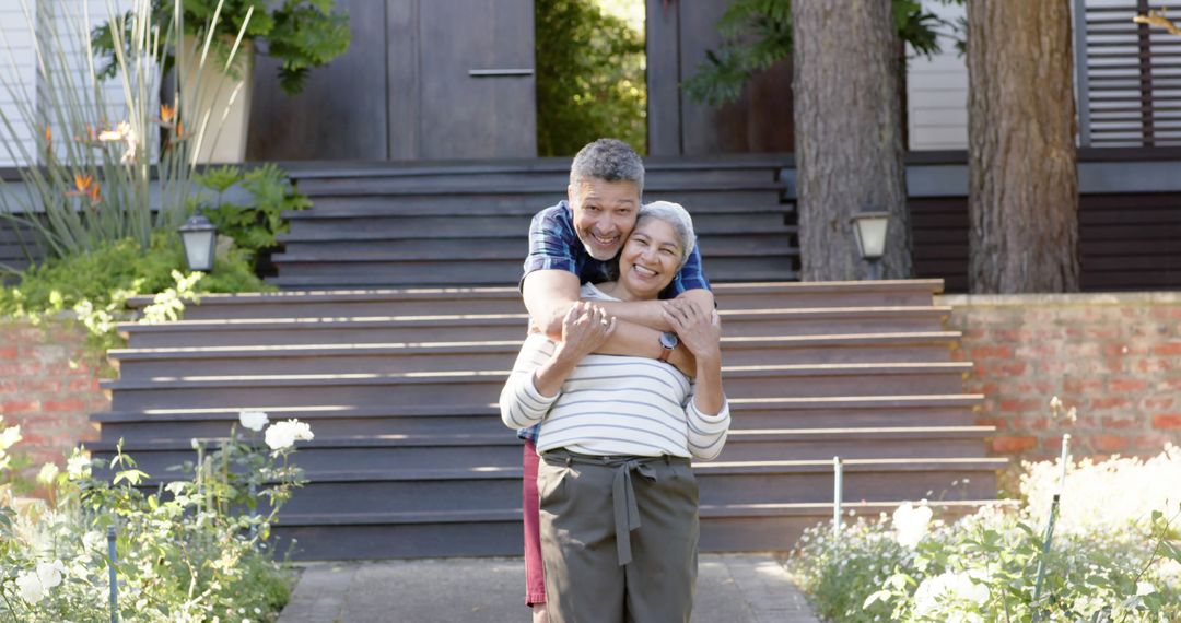 Senior Couple Embracing Outdoors in Front of Home - Free Images, Stock Photos and Pictures on Pikwizard.com