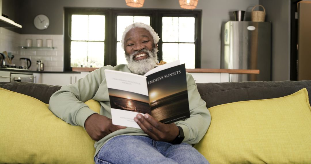 Senior Man Relaxing on Sofa Reading Book in Cozy Living Room
