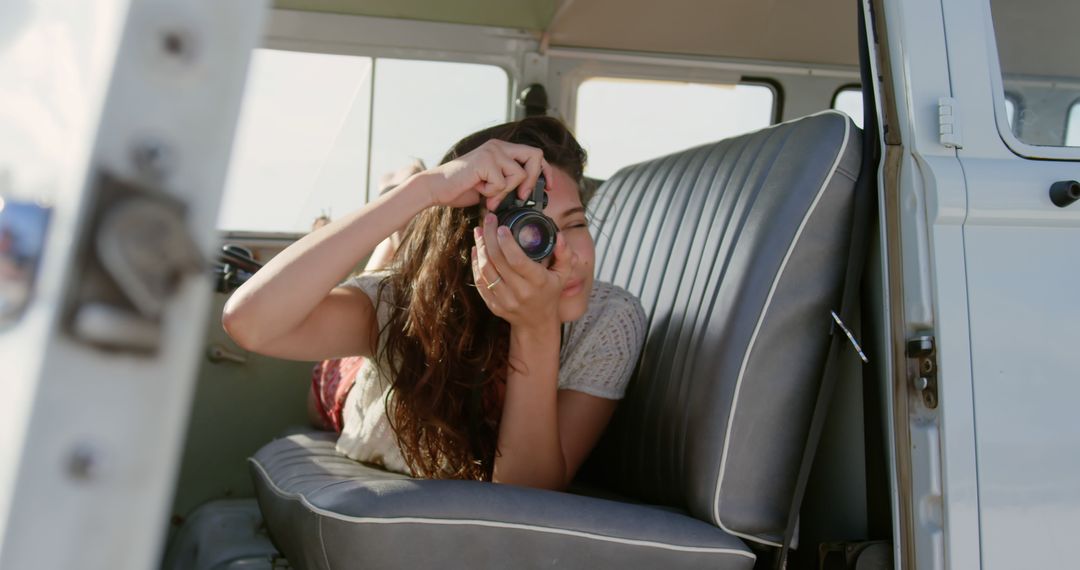 Young Caucasian woman captures memories from a vintage van - Free Images, Stock Photos and Pictures on Pikwizard.com