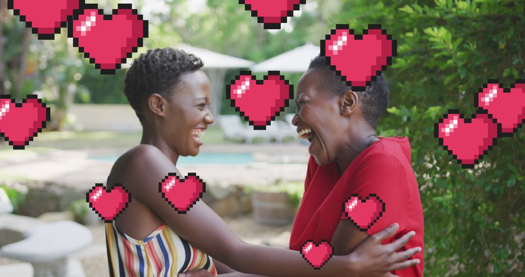 Two Women Laughing Together Surrounded by Pixelated Hearts Outdoors - Free Images, Stock Photos and Pictures on Pikwizard.com