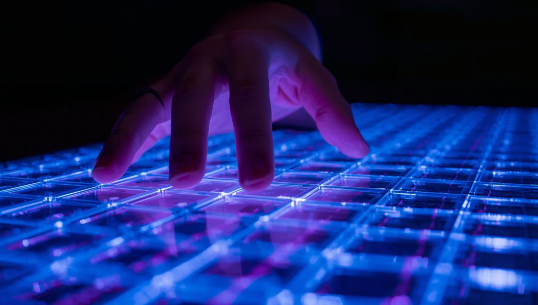 Futuristic Hand Hovering over Illuminated Neon Grid Panel for Interactive Tech Concept