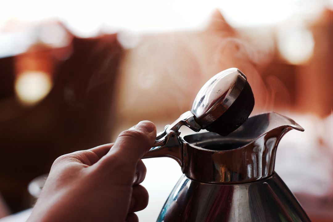 Person Brewing Coffee with Metallic Espresso Pot - Free Images, Stock Photos and Pictures on Pikwizard.com