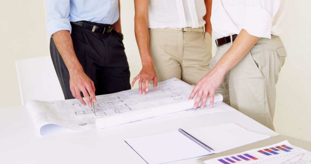 Team of Professionals Reviewing Architectural Blueprints - Free Images, Stock Photos and Pictures on Pikwizard.com