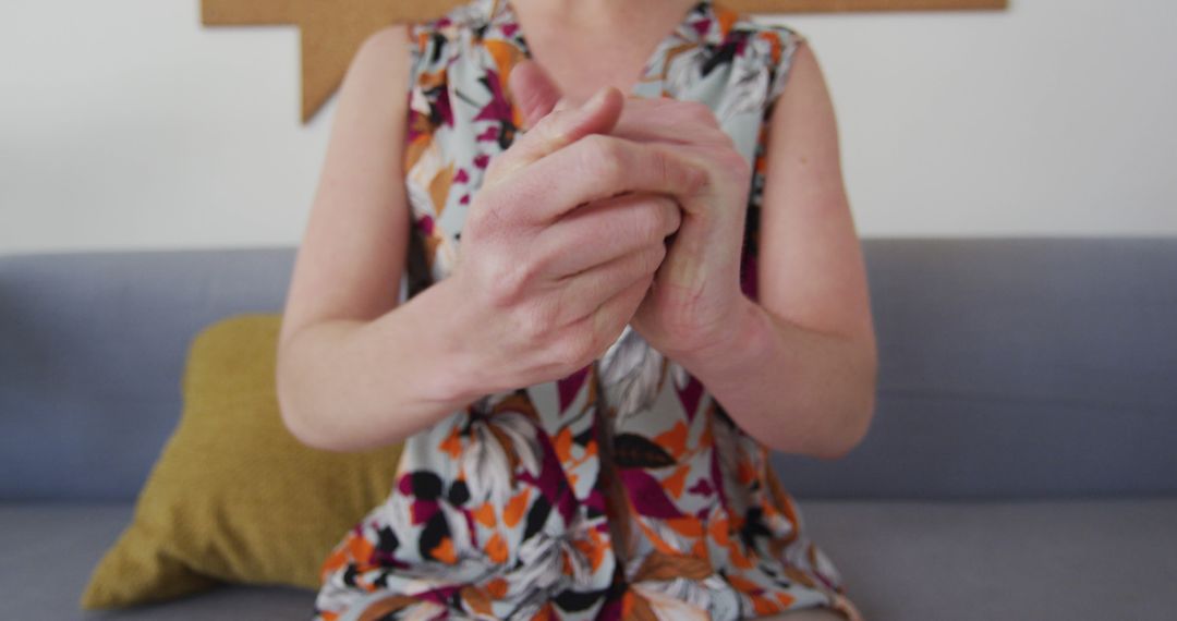 Close-Up of Woman's Hands Clasped Together in Colorful Blouse - Free Images, Stock Photos and Pictures on Pikwizard.com