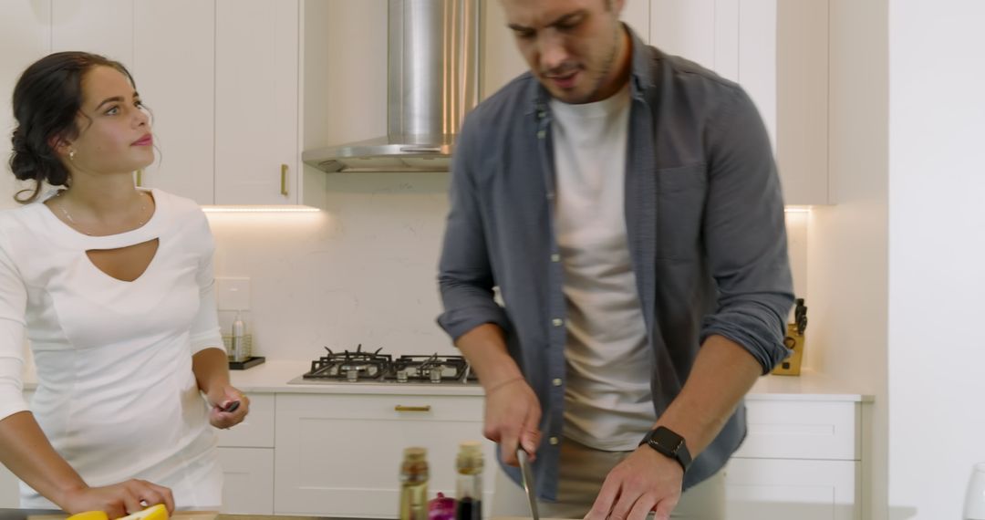 Couple Enjoying Breakfast Preparation Together in Modern Kitchen