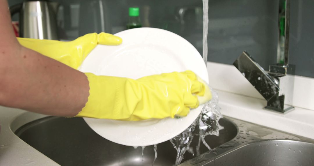 Hands Washing Plate with Yellow Gloves in Kitchen Sink - Free Images, Stock Photos and Pictures on Pikwizard.com