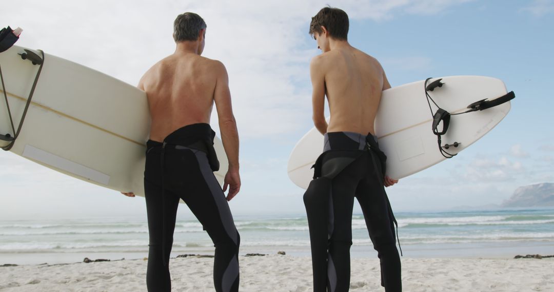 Father and Son Bonding Time Carrying Surfboards on Beach - Free Images, Stock Photos and Pictures on Pikwizard.com