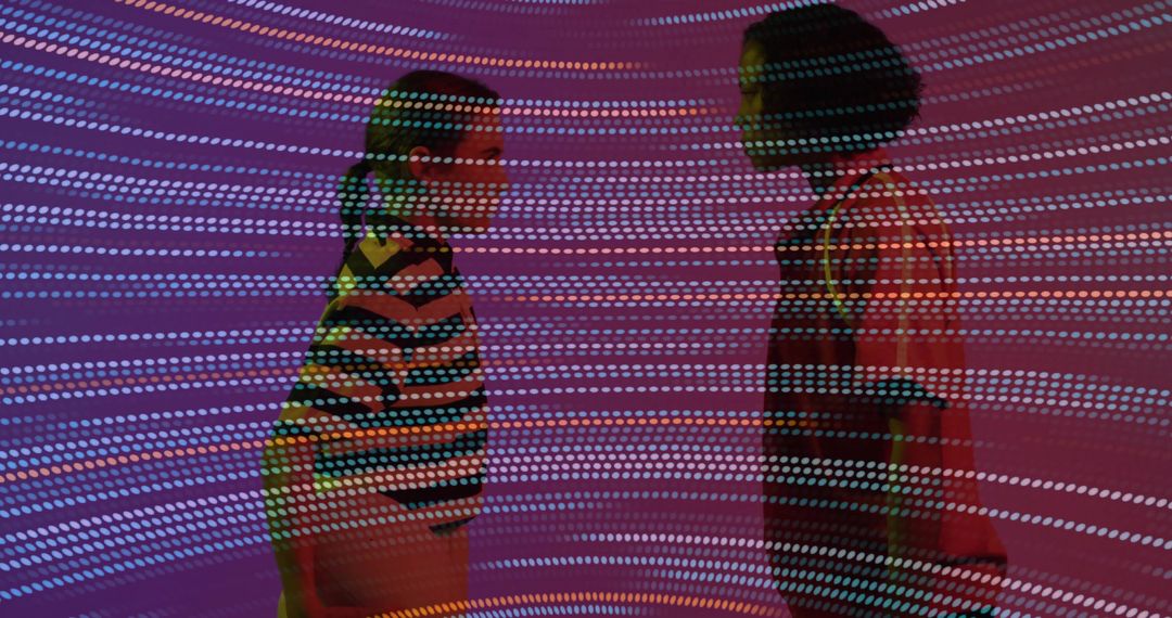 Women Experiencing Interactive Exhibit with Vibrant Light Patterns