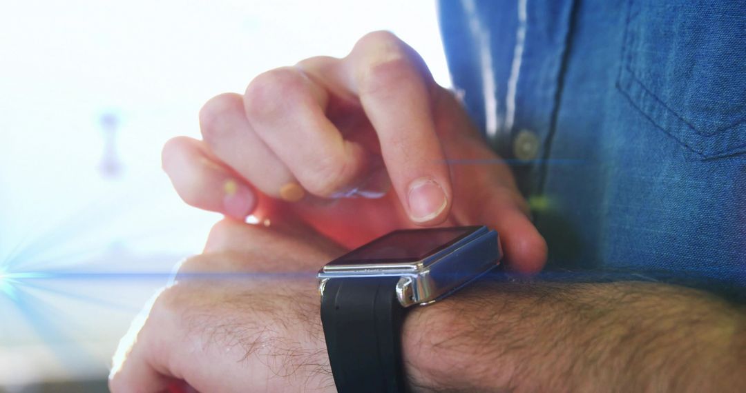Person Using Smartwatch with Lens Flare and Denim Sleeve