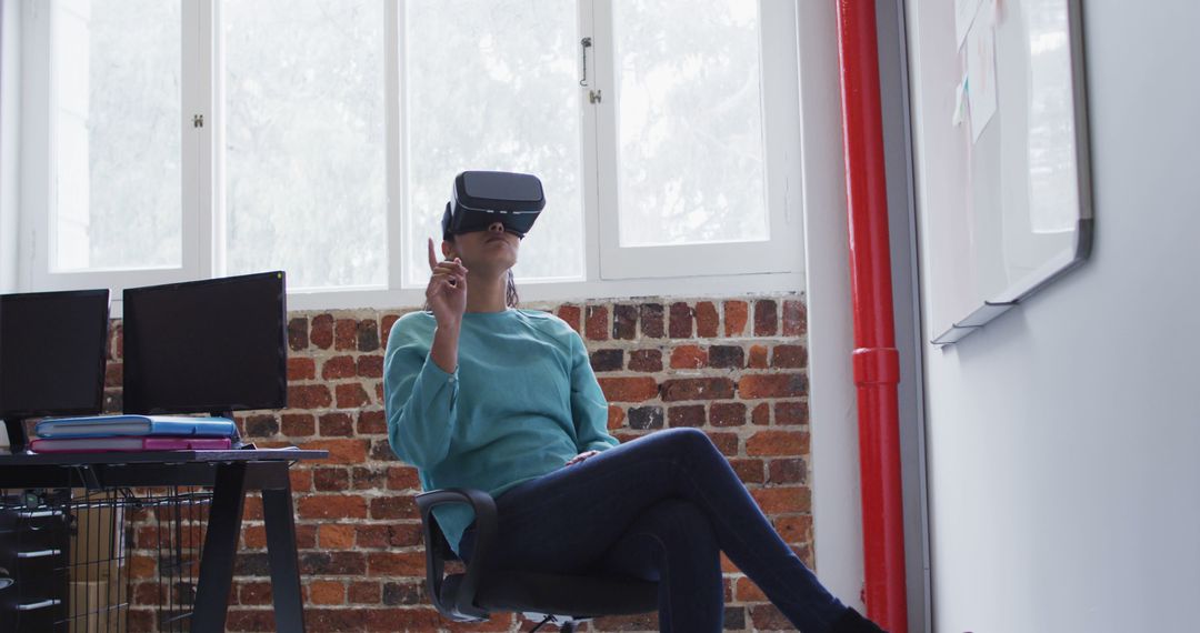 Woman Engaging with Virtual Reality in Brick-walled Office - Free Images, Stock Photos and Pictures on Pikwizard.com