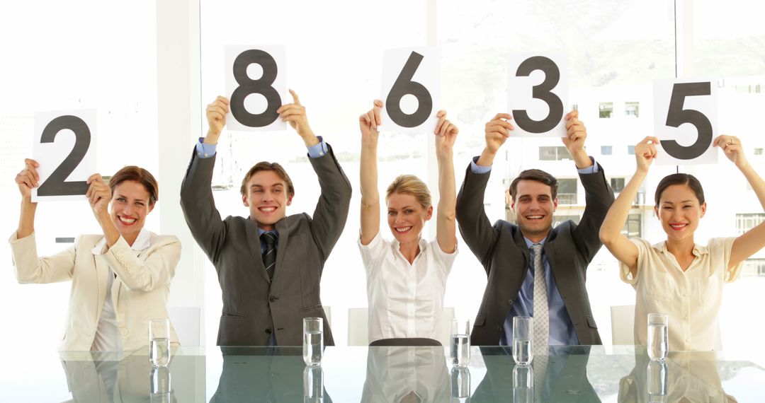 Business Team Holding Score Cards in Office Meeting Room - Free Images, Stock Photos and Pictures on Pikwizard.com