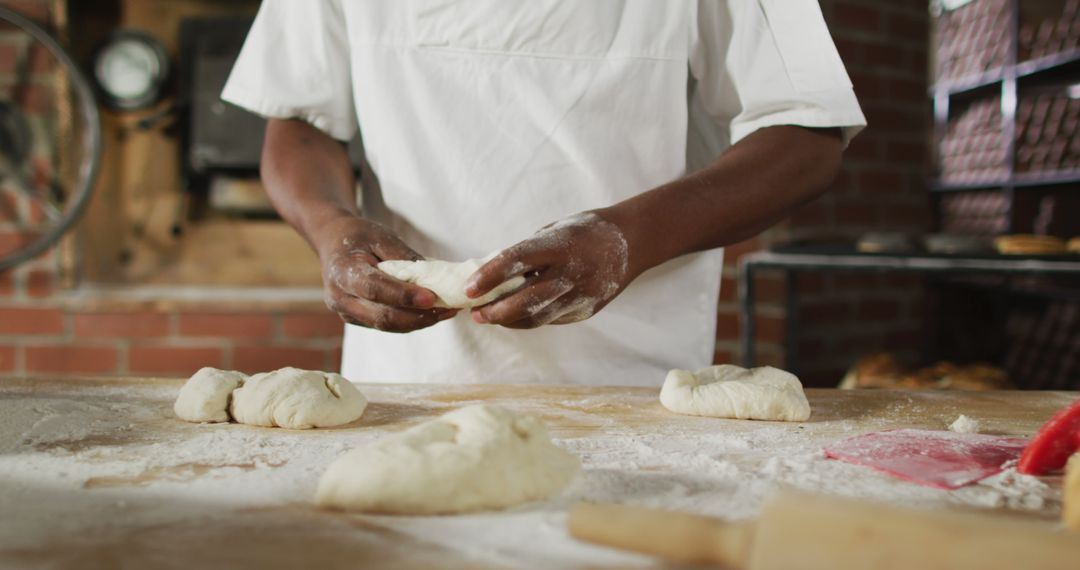 Baker Kneading Dough in Rustic Bakery - Free Images, Stock Photos and Pictures on Pikwizard.com