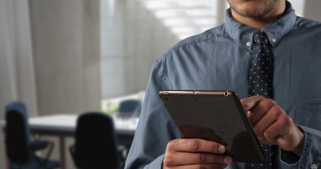 Business Professional Using Tablet in Modern Office Setting