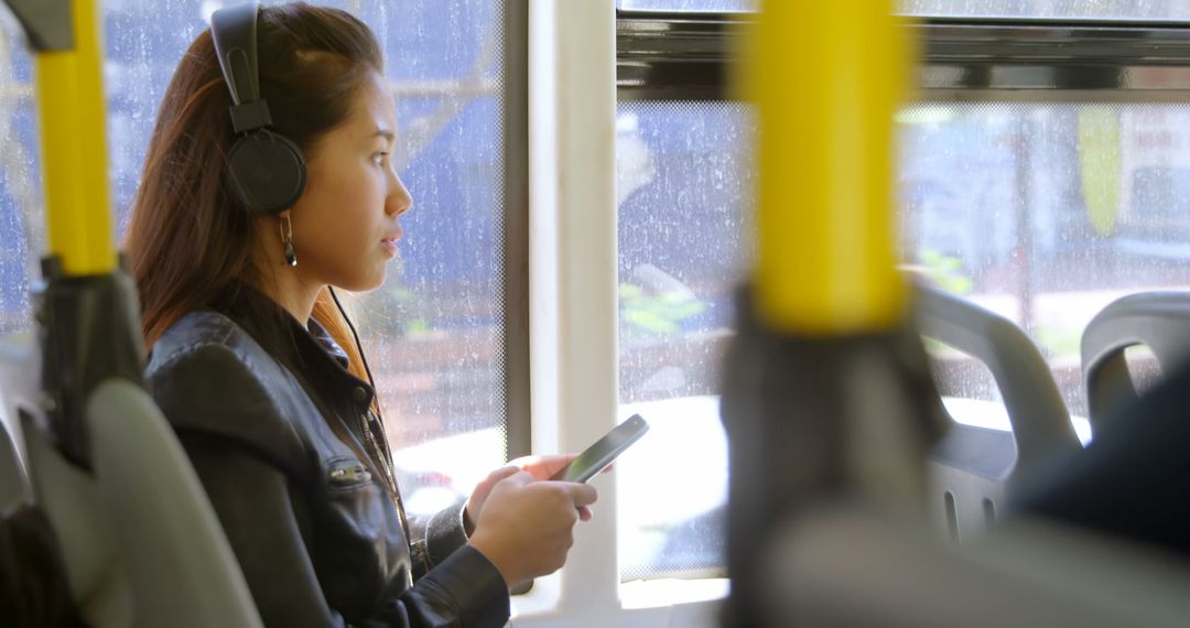 Woman Listening to Music with Headphones on Bus - Free Images, Stock Photos and Pictures on Pikwizard.com