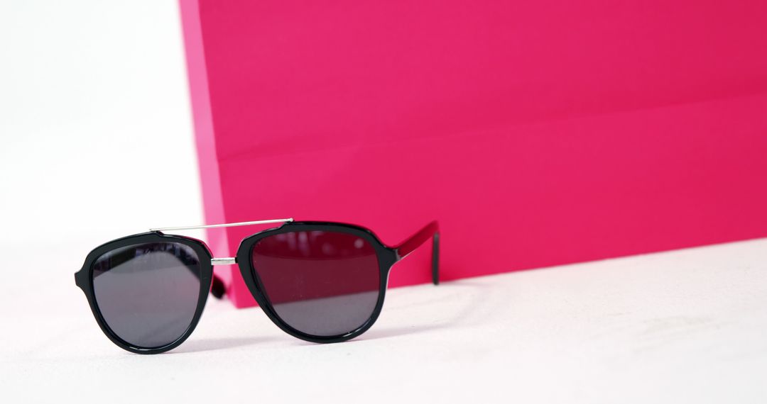 Modern Sunglasses on White Surface with Pink Background - Free Images, Stock Photos and Pictures on Pikwizard.com