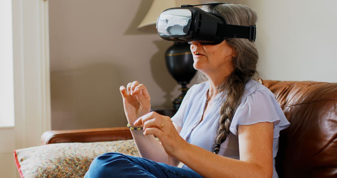 Older Woman Experiencing Virtual Reality at Home - Free Images, Stock Photos and Pictures on Pikwizard.com