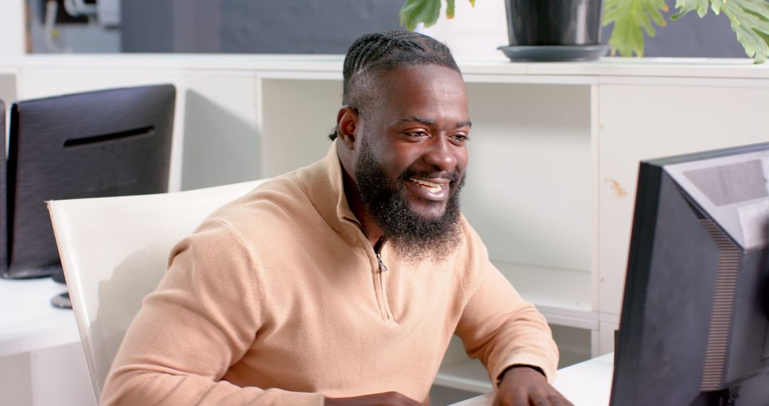 Portrait of African American Man Focused on Computer in Office Environment