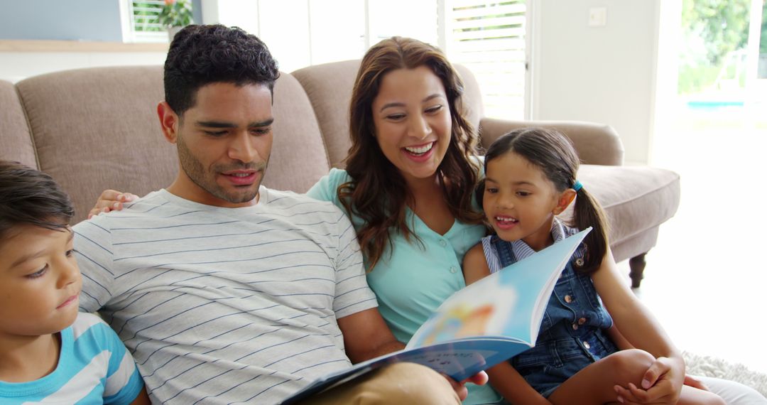 Smiling Family Reading Book Together in Living Room - Free Images, Stock Photos and Pictures on Pikwizard.com