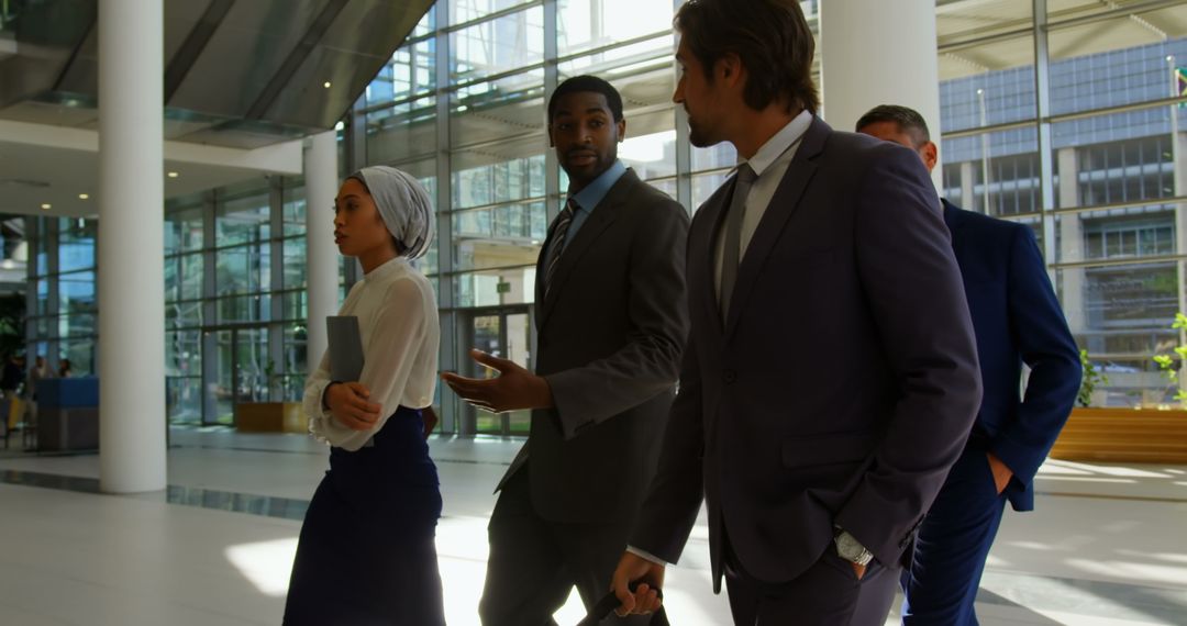 Diverse Business Professionals Walking in Office Atrium