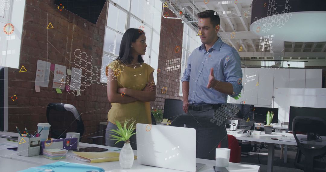 Coworkers Analyzing Data Visualizations in Modern Office Space