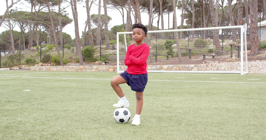 Youthful Soccer Player on Field with Ball