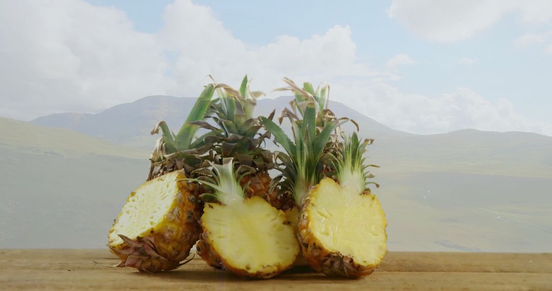 Tropical Pineapples on Wooden Table with Mountainous Backdrop