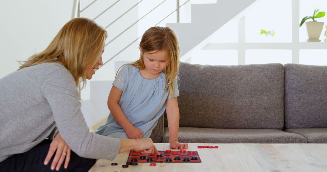 Mother and Daughter Playing Checkers in Bright Modern Living Room - Free Images, Stock Photos and Pictures on Pikwizard.com