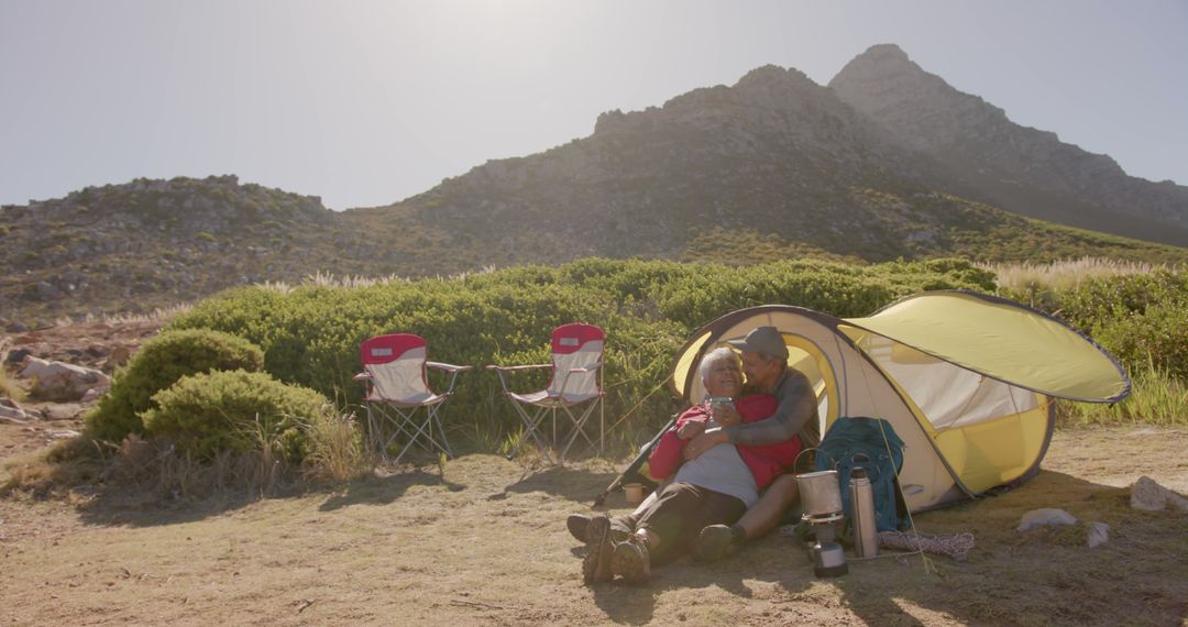 Happy Senior Couple Relaxing on Mountain Camping Trip