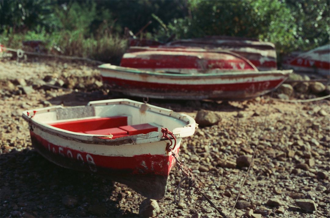 Abandoned Red Rowboats on Dry Riverbed - Free Images, Stock Photos and Pictures on Pikwizard.com