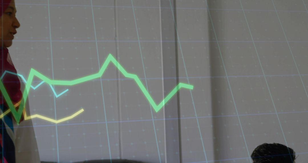 Hijab-Wearing Businesswoman Presenting Modern Office Graph Presentation