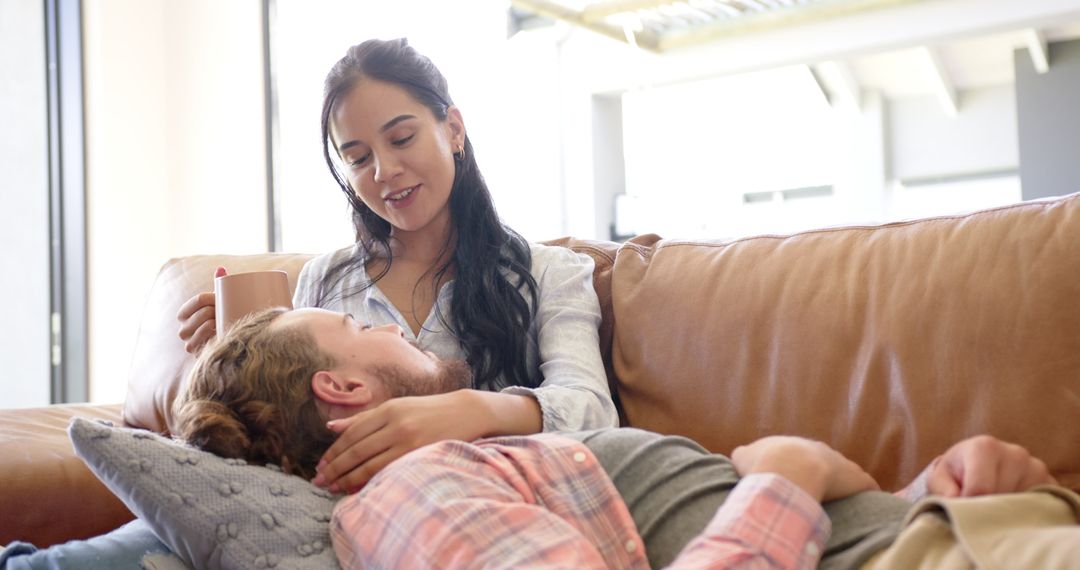 Couple Sharing Tender Moment Relaxing on Sofa at Home
