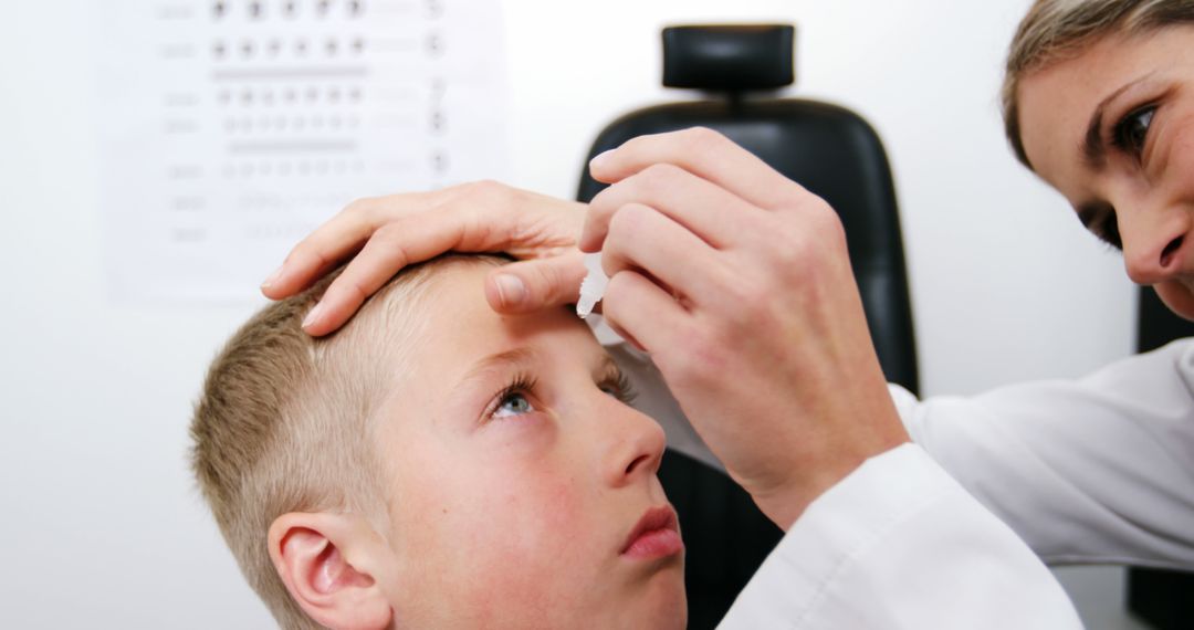 Ophthalmologist Administering Eye Drops to Young Boy in Clinic - Free Images, Stock Photos and Pictures on Pikwizard.com