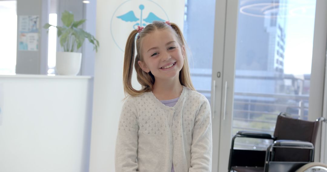 Cheerful Girl Smiling in Hospital Reception Area