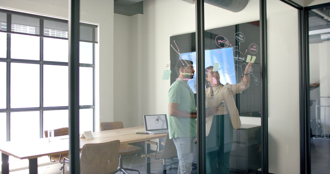 Colleagues Brainstorming with Digital Whiteboard in Modern Office