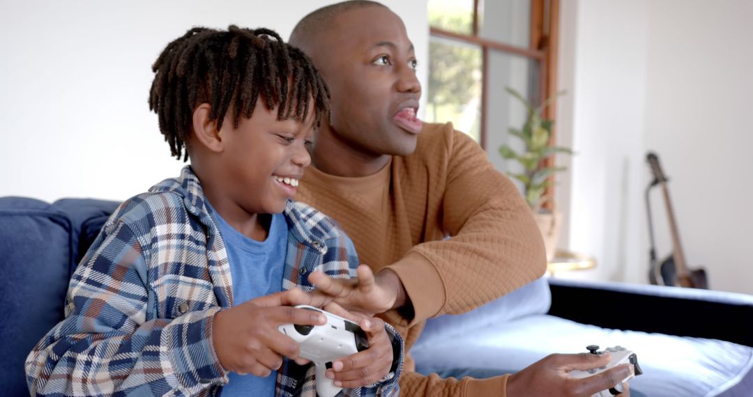 Father and Son Enjoying Video Game Indoors - Free Images, Stock Photos and Pictures on Pikwizard.com