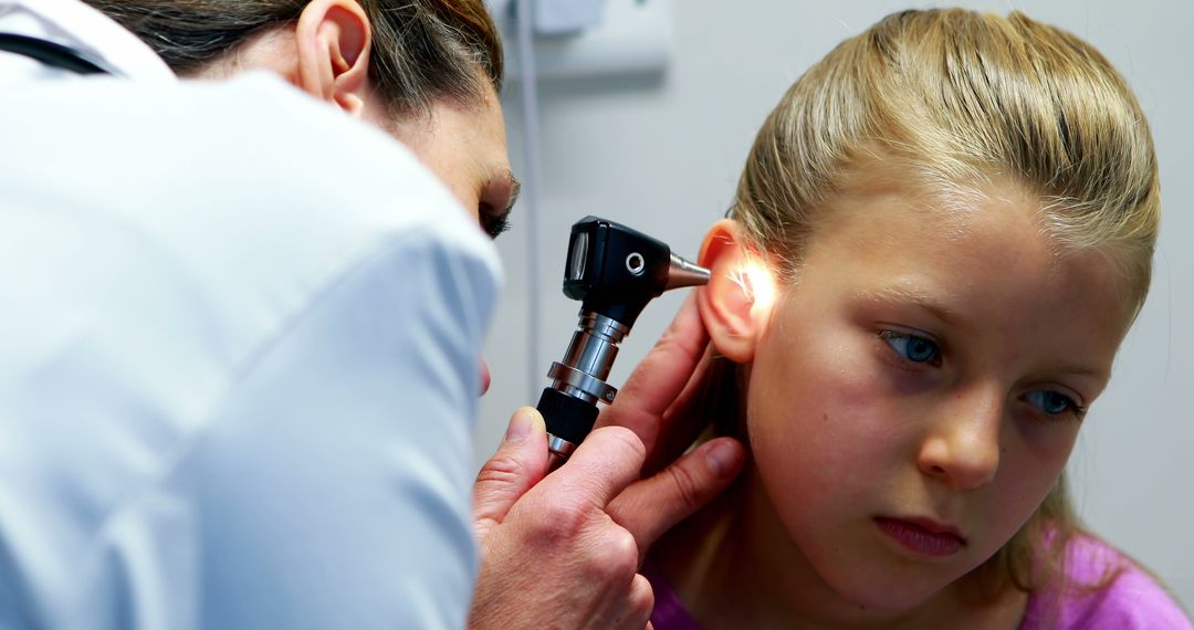 Doctor Examining Young Girl's Ear with Otoscope - Free Images, Stock Photos and Pictures on Pikwizard.com