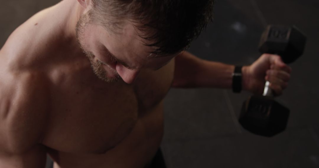 Athletic Man Performing Dumbbell Curls in Gym for Cross Training