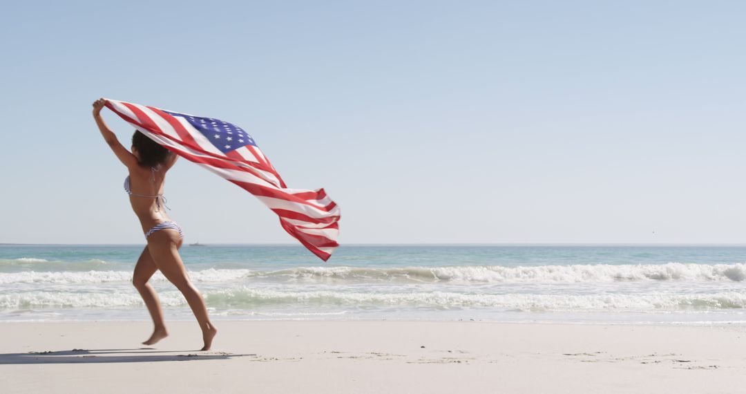 Happy Biracial Woman Running with USA Flag at Beach - Free Images, Stock Photos and Pictures on Pikwizard.com