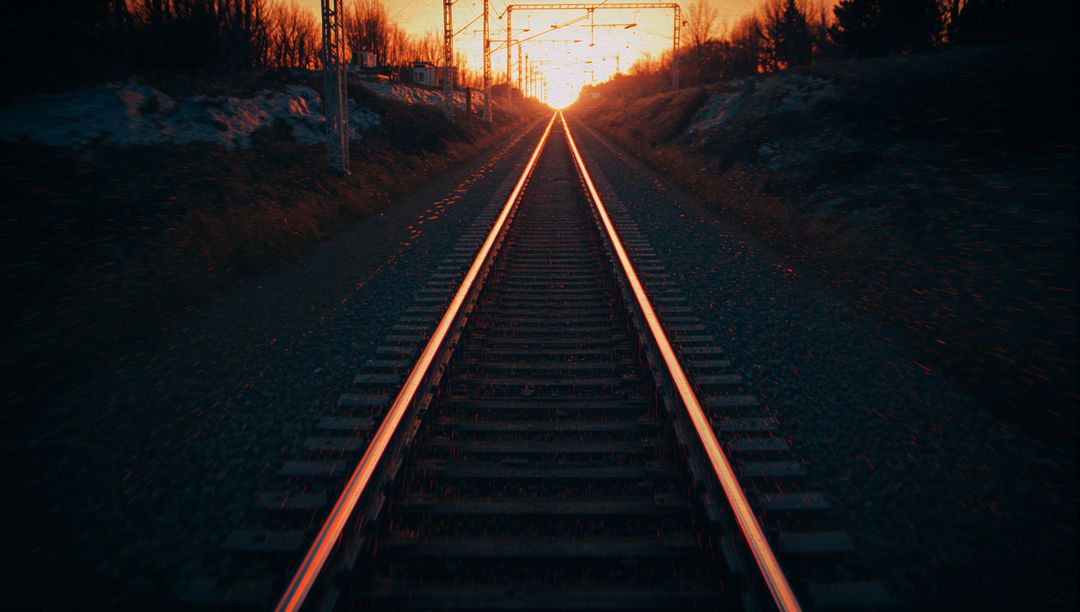 Sunset Glow on Railway Tracks Leading to Distant Horizon