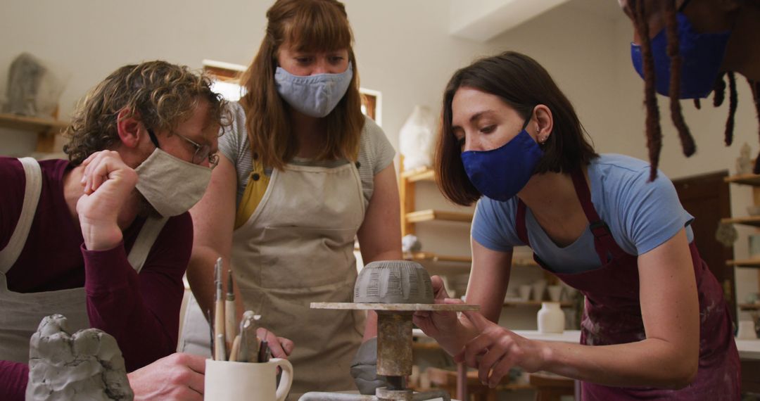 Group of Adults Enjoying Pottery Class Wearing Protective Masks - Free Images, Stock Photos and Pictures on Pikwizard.com