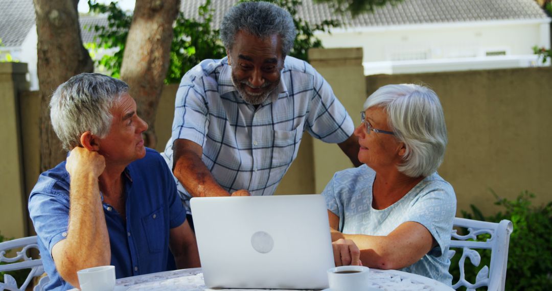 Senior Adults Enjoying Leisure Time with Laptop in Outdoor Cafeteria - Free Images, Stock Photos and Pictures on Pikwizard.com