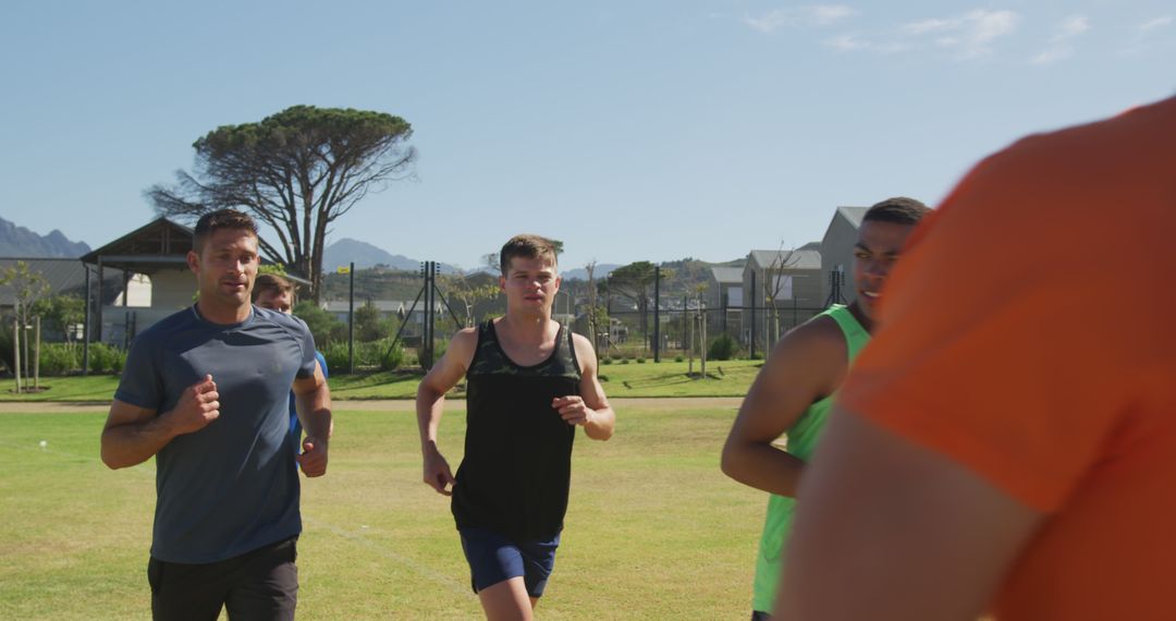 Group of Men Running Outdoors on Sunny Day - Free Images, Stock Photos and Pictures on Pikwizard.com