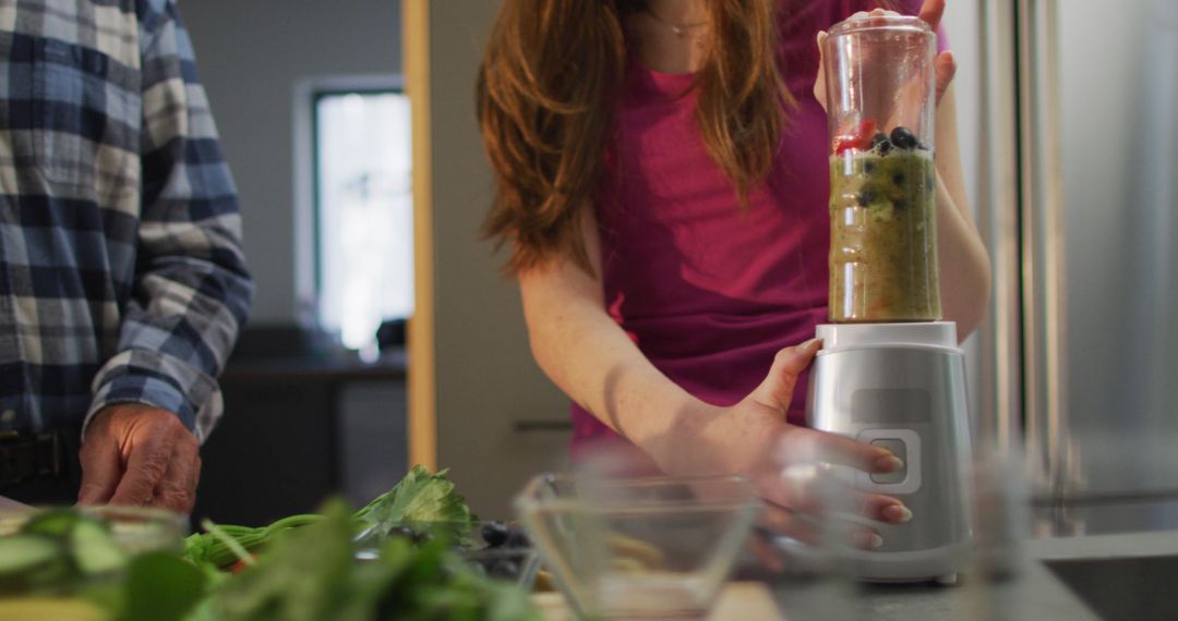 Woman Using Blender to Make Healthy Smoothie in Kitchen - Free Images, Stock Photos and Pictures on Pikwizard.com