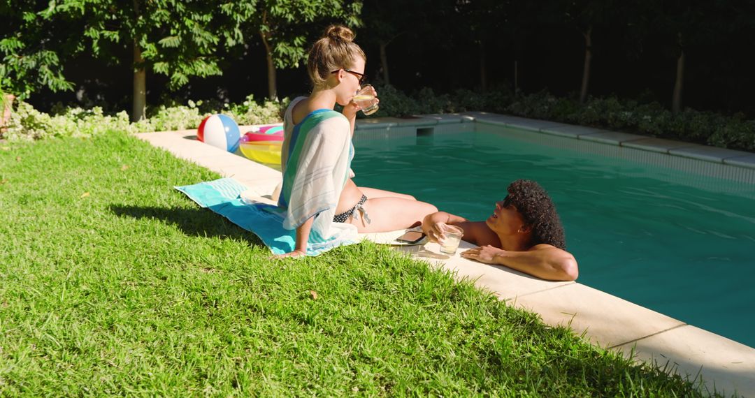 Couple Relaxing by Backyard Pool Enjoying Summer Day